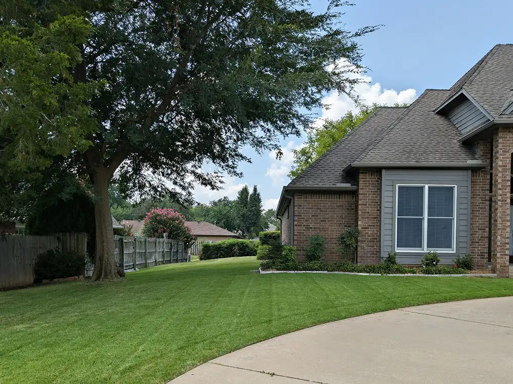 schedule-your-lawn-care-services a house with a maintained lawn